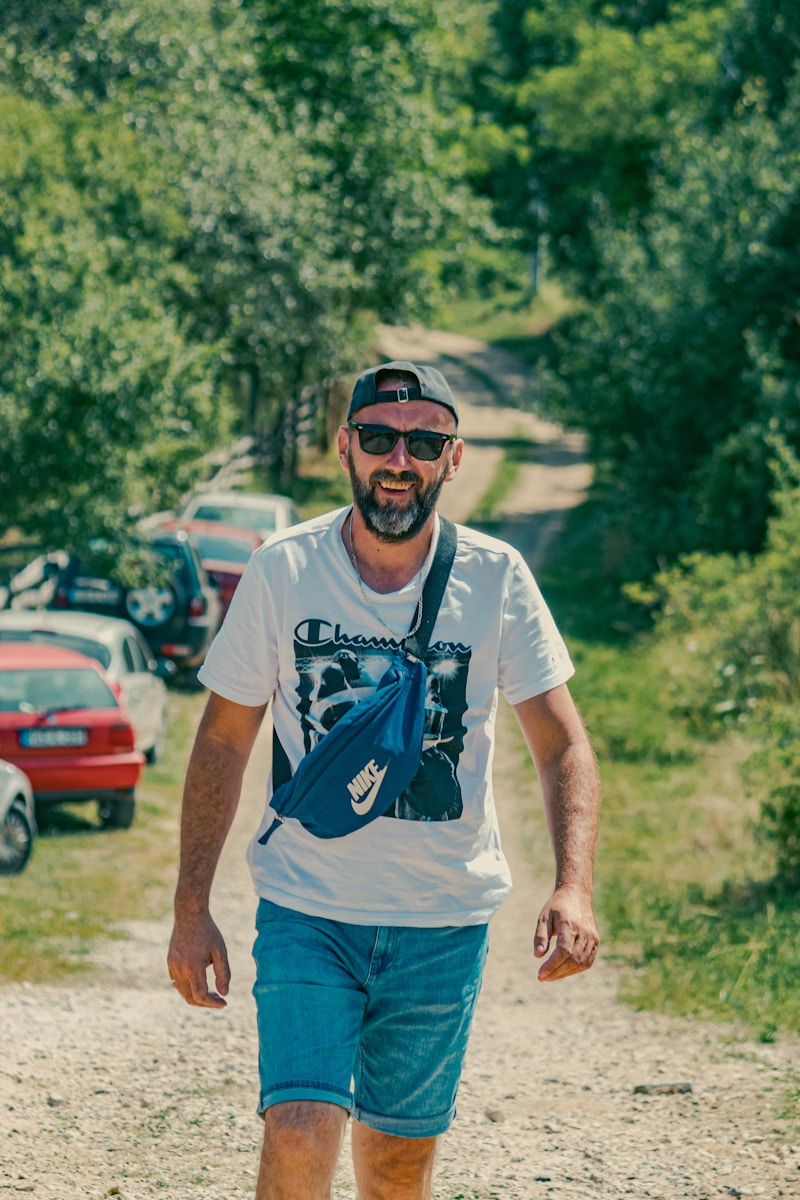 a man riding a skateboard down a dirt road
