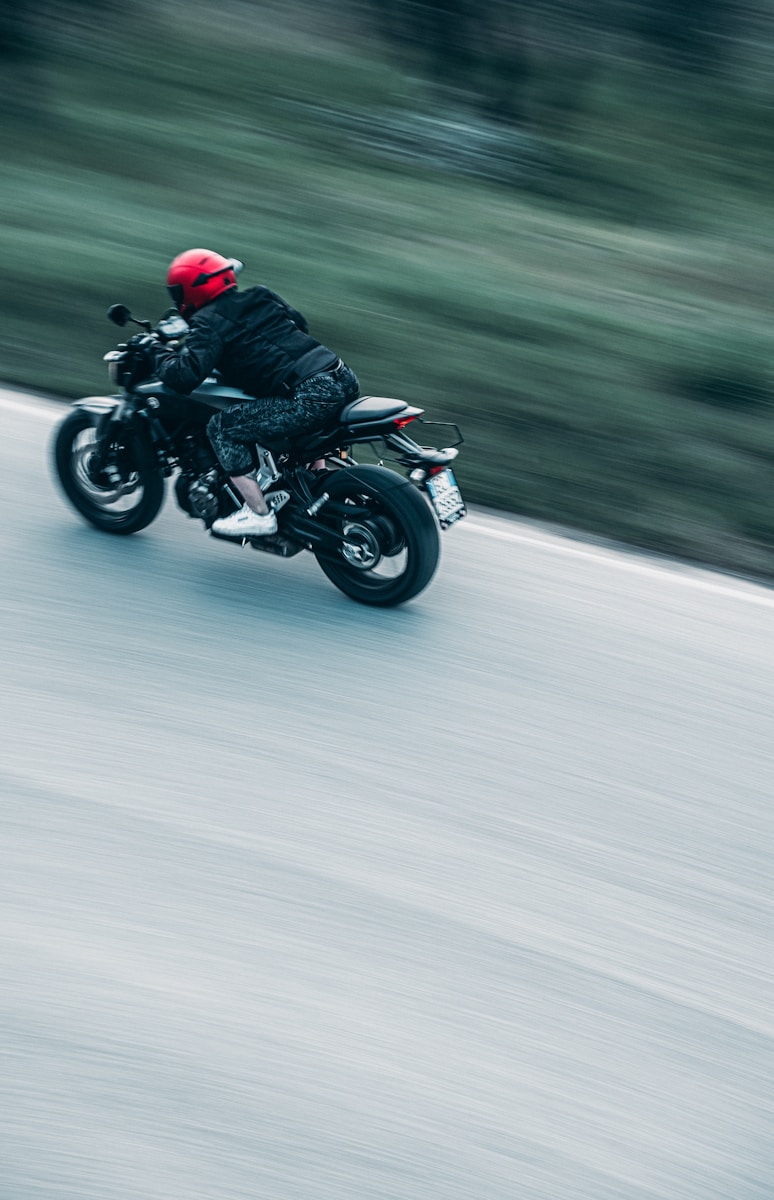a man riding a motorcycle down a street